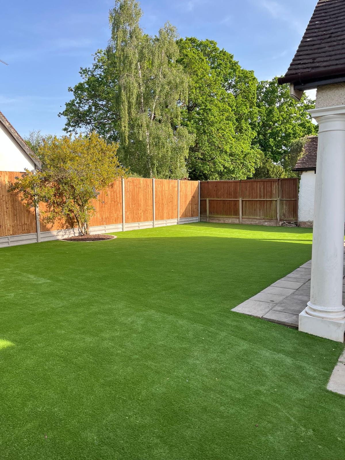 Finished artificial grass lawn with new close board fencing installed by John Ruben Ltd in Potters Bar