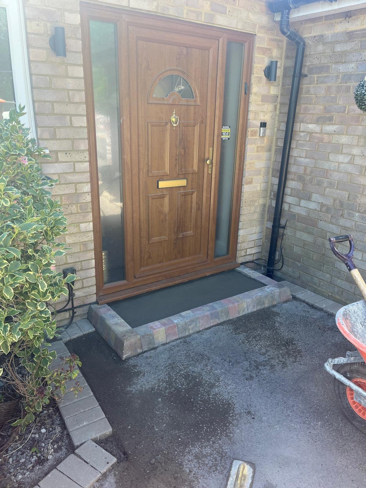 Rebuilt front doorstep with block paved edging and new surfacing by John Ruben Ltd in Potters Bar